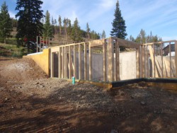 Dirt and gravel surrounding wooden framework for new home construction