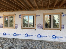 Partially-finished home with barricade wrap on exterior wall