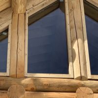 Slanted window on upper level of custom log cabin