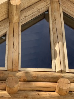 Slanted window on upper level of custom log cabin