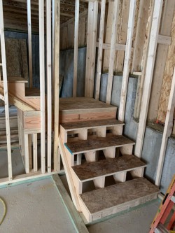 Wooden framework for walls and staircase of new home construction
