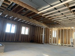 Framework for custom home with cement flooring and installed windows