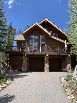 Three story mahogany cabin with wraparound wooden deck