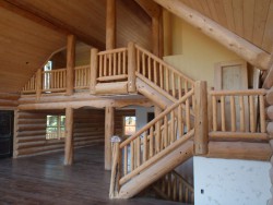 Log cabin with wooden staircases, railings and support beams