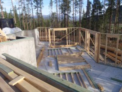 Framework for wooden deck overlooking mountains and large trees