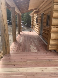 Log cabin and multitoned wooden front porch