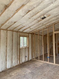 Framework for custom home with insulation and installed window