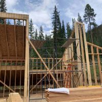 Framework for custom home surrounded by large trees