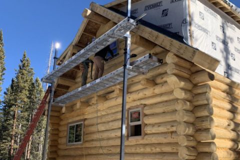 Working on the exterior second level of a custom home