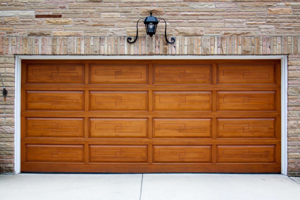 Two car garage with cherry-wood door and slate exterior