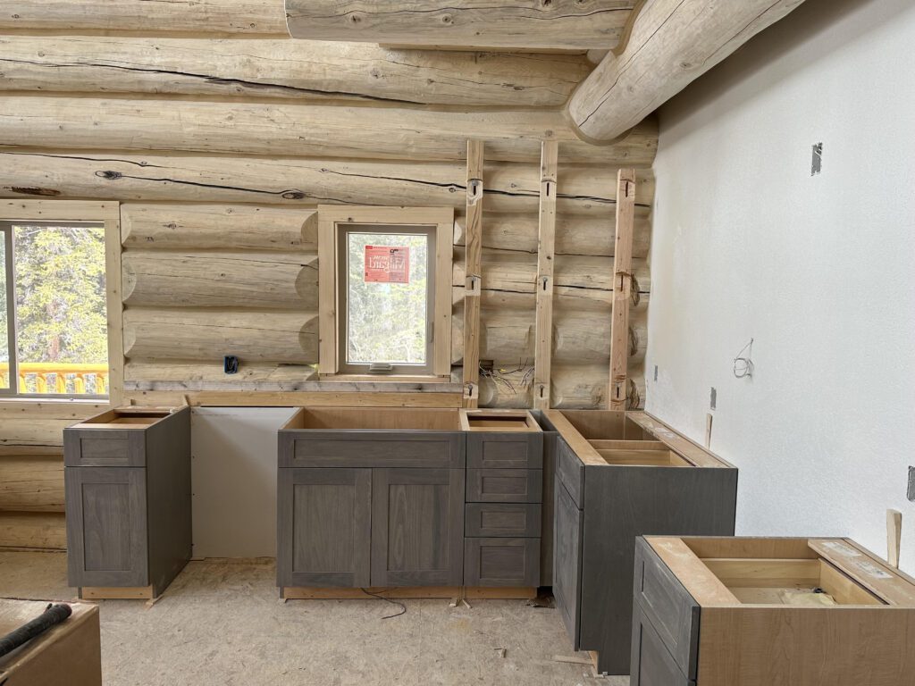 Kitchen remodel with pine overhead beams and gray wood cabinets